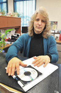 Southwick Town Clerk Michelle L. Hill, displays a set of documents and a compact disc that someone ordered which town employees spent 10-hours to compile as part of the Request for Information process. (Photo by Frederick Gore)