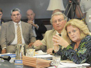 Westfield State University vice president of administration and finance, Milton Santiago, seated left, watches in the background as Westfield State University Trustees Terry M. Craven, right, and James P. Ruberto, center right, question WSU President Dr. Evan Dobelle, not shown, during an August 29 meeting at the university. Santiago resigned this week. (File photo by Frederick Gore) 