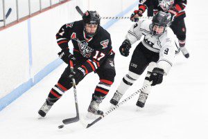 Westfield's Chris Sullivan, left, controls the puck as Longmeadow senior forward captain Drew Kelleher, right, moves in during the second period Tuesday night at the Olympia in West Springfield. (Photo by Frederick Gore)