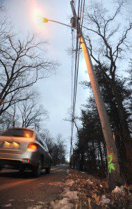 IA utility pole on Montgomery Road was broken Saturday afternoon when a pickup truck slid off the road and struck it but the pole remains upright and the street light is still working. No injuries were reported and the pickup was towed from the crash scene but, apparently, the pole is okay. (Photo by Carl E. Hartdegen)