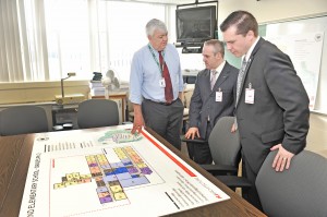 Southwick Superintendent of Schools John D. Barry, left, explains an illustrated drawing of the newly redesigned Woodland Elementary School to Massachusetts Secretary of Education Matthew H. Malone, center, and State Rep. Nicholas Boldyga during a tour of the school district yesterday. (Photo by Frederick Gore)