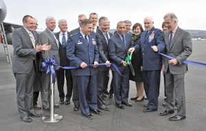 Gov. Deval Patrick, center, cuts a ceremonial ribbon at Barnes Regional Airport as state, local and military dignitaries join the celebration. Patrick was on hand to speak on the new 9,000-foot runway project that was recently completed. (Photo by Frederick Gore)