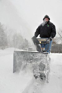 A white vapor cloud of condensation from the breath of James Fahey, of Southwick, can be seen as he snowblows his driveway Friday morning. Frigid temperatures moved into the area Thursday as the snow arrived. (Photo by Frederick Gore)