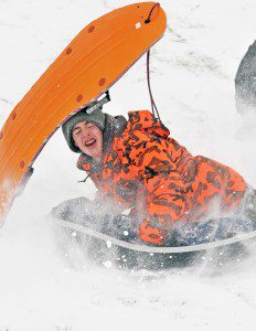 Sullivan Webster, of Westfield, is hit by a friend's sled while sliding at the Southwick-Tolland-Granville High School Thursday. 