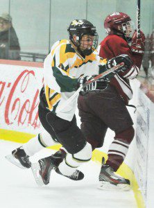 St. Mary junior forward Andrew Booth, left, checks an Easthampton player into the boards during a January 2014 regular season game. Booth, now a senior, will serve as assistant team captain this year. (Photo by Frederick Gore)