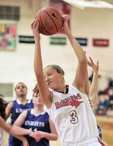 Westfield's Alicia Arnold, foreground, collects the rebound during last night's game against visiting Holyoke. (Photo by Frederick Gore)