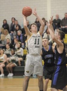 Southwick junior forward Jonathan Collins, left, looks for the net during the second period of last night's game against visiting Monson. (Photo by Frederick Gore)