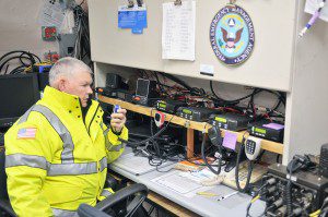 Charles Dunlap, director of the Southwick Emergency Management Agency, checks a set of emergency communication radios at the Southwick Town Hall prior to Thursday night's snowstorm. (Photo by Frederick Gore)