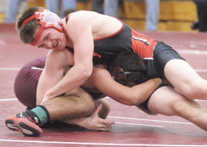 Westfield's Aundre Popchuck, top, competes in the 152-class during last night's wrestling meet with Ludlow. (Photo by Frederick Gore)