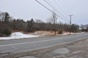 A piece of land where a house once stood on the south side of Route 57 near the Southwick / Agawam town line is now overgrown with vegetation. The home was purchased and razed to make way for the Route 57 expansion project. (File photo by Frederick Gore)