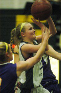 Makenzie Sullivan drives to the basket in between two Cathedral defensive players. (Photo by Chris Putz)