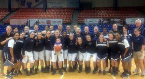 Members of the Westfield State and Mount Holyoke teams meet at midcourt prior to their game in San Juan, Puerto Rico.
