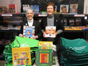 Susan Jaye-Kaplan, left, and Francie Cornwall display some of the books included in the Link to Libraries' Welcome to Kindergarten bags. Jaye-Kaplan hopes to bring the program to Westfield. (Photo by Hope E. Tremblay)