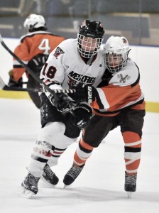 Westfield's Joshua Adams, left, tangles with an Agawam defender. (Photo by Frederick Gore)