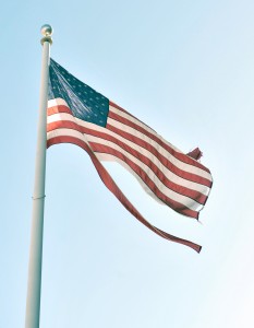 A battered flag flies over the General Shepard Apartments. (Photo by Frederick Gore)