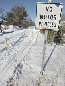 Snowmobile and ATV tracks are clearly visible at the Congamond Road Rail-to-Trail location despite a large sign indicating otherwise. (Photo by Frederick Gore)