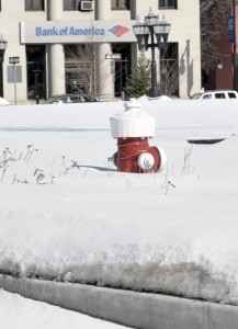 A fire hydrant located in the Park Square Green remains buried in snow Monday. (Photo by Frederick Gore)