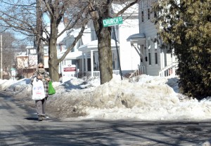 A woman walks along a traffic lane on Washington Street as many sidewalks around the city remain icy. (Photo by Frederick Gore)
