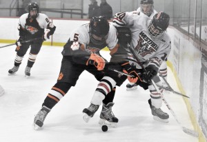 Westfield freshman forward Max Bengston, right, battles South Hadley defenseman Brian Bak during a recent game at the Olympia Ice Arena. The Bombers will begin defense of their 2012-13 title, beginning Saturday against the Longmeadow Lancers at the Olympia in West Springfield at 1 p.m. (File photo by Frederick Gore)