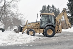 Heavy equipment from the Southwick Department of Public Works was dispatched early this morning to remove high snowbanks which interfered with drivers visibility.  More snow was predicted for today. (Photo by Frederick Gore)