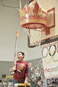 Seth Doe, from the United States, lights the Olympic cauldron as he announces the Olympic proclamation. (Photo by Frederick Gore)