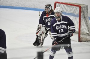 Cathedral goalie Lexi Levere and defenseman Mackenzie Pelletier (13) protect the net against Auburn during the 2013-14 regular season. (Submitted photo)
