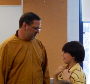 Retiring teacher Steve Estelle, wearing his cowardly lion costume, took time to say goodbye to students on his last day of teachings. Shown here he's speaking with Trent Larson. (Photo submitted)