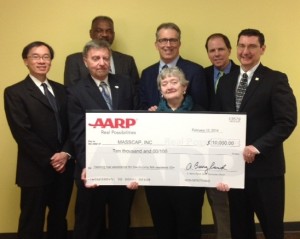 From left bottom row, holding check, John Drew, president/CEO, ABCD, help AARP Massachusetts State President Linda Fitzgerald and AARP Massachusetts State Director Mike Festa hold a check for $10,000, presented to MASSCAP for emergency heating fuel assistance.  Also pictured, from left top row is Leverett Wing, associate director, Division of Community Services, Department of Housing and Community Development (DHCD), Paul Bailey, president, MASSCAP, Joe Diamond, executive director, MASSCAP, and John Hishta, senior vice president, AARP Campaigns. (Photo submitted)