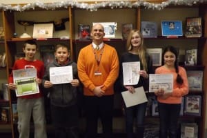 The annual library bookmark contest at North Middle School was held during the month of January.  The winners are from left to right: Anthony Pikula, Nikita Romanenko, Principal Christopher Rogers, Amanda Beswick, and Darina Viktorchuk.  The winning bookmarks will also be entered in the Massachusetts School Library Association Bookmark Contest. (Photo submitted)
