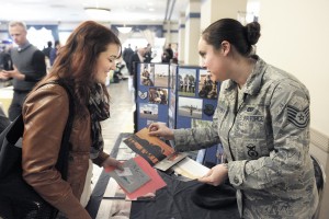 TSgt. Heather Cekovsky, right, a recruiter from the Massachusetts Air National Guard, explains some of the many programs available to Whitney Johnson, a student at Westfield State University, during a career fair staged at Scanlon Hall on the university campus yesterday. (Photo by Frederick Gore)