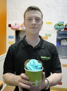 Greg Strattner, manager of MoFroYo Frozen Yogurt in Westfield, displays a Blueberry froyo as part of Autism Awareness Month. The store will also feature Cotton Candy blue. (Photo by Frederick Gore)