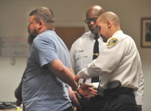 Court officers William Ballard and Luis Otero take Eric Lemire of Wesfield into custody after the judge set bail at $20,000 in a case in which Lemire is charged, again, with stealing from his 89-year-old great-aunt. (Photo by Carl E. Hartdegen)