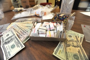 Bundles of heroin packets, a large amount of cash and paraphernalia were seized when a warrant was executed Wednesday and a pair of alleged heroin retailers were arrested. (Photo by Carl E. Hartdegen)
