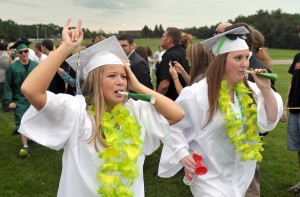 Students from the Southwick-Tolland Regional High School celebrate their graduation in the soccer field of the Powder Mill Middle School as part of a long-standing tradition. This year the ceremony will be staged indoors due to the renovations of the present track and field. The high school is in the background. File photo by Frederick Gore)