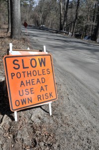 A large reflective sign warns drives to use a portion of Shaker Road in Westfield at their own risk after large potholes have been reported citywide. (Photo by Frederick Gore)