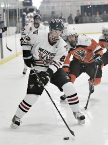 Westfield's Craig Lacey, foreground, controls the puck during the first period against Agawam last month. (File photo by Frederick Gore)
