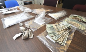 Cash, heroin, marijuana and an unusually large amount of cocaine are spread out on a table at the Westfield Police Department as it is organized for analysis after it was seized in a raid on a drug house in the city Friday. (Photo by Carl E. Hartdegen)