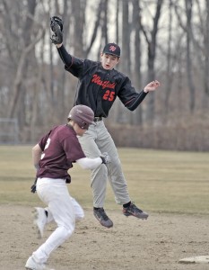 Westfield first baseman Kenny McClean leaps for the catch as a Ludlow runner beats the tag. (Photo by Frederick Gore)