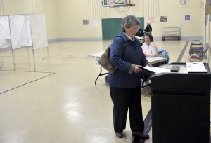 Candy Pennington places her ballot in a voting machine this morning at the Ward 4B location. Voters will be casting their ballots for Westfield's next State Representative during today's special election. (Photo  by Frederick Gore)