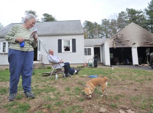 Louise Moran and her husband, Anthony, stand in their front yard with ‘Baxter’, their American Chihuahua puppy who they say alerted them to a fire in their garage Friday afternoon. (Photo by Carl E. Hartdegen)