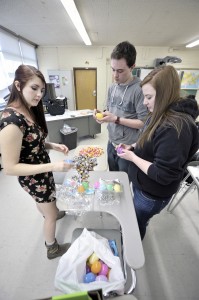 Ashley Lees, Samuel Sprague, and Megan Ilnicky, all from the National Technical Honor Society of Westfield Vocational-Technical High School, stuff candy in plastic Easter eggs that will be part of the Mayor's Easter Egg Hunt. (Photo by Frederick Gore)