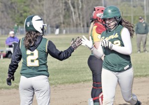 Southwick's Samantha Burzynski, left, congratulates Alyssa Kelleher, right, for tacking on another run during Thursday's game against Holyoke Catholic. (Photo by Frederick Gore)