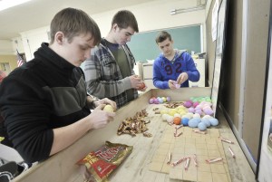 Westfield Vocational-Technical High School students, left-right, Dan Romanenko, Ed Chekhovskiy, and Dan Gavrilyuk, help stuff more than 500 Easter eggs with candy in preparation of the upcoming 20th Annual Easter Egg hunt at Shaker Farms Country Club, Saturday. The three are part of the National Technical Honor Society. (Photo by Frederick Gore)