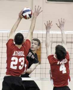 Westfield High School's John Bucko, rear, leaps for the block as a pair of Athol High School players attack. (Photo by Frederick Gore)