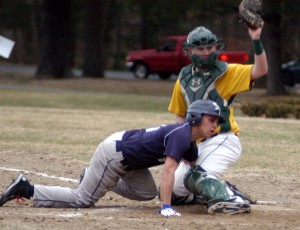 St. Mary catcher Brendan Gawron holds up his mitt to show the umpire the ball after successfully tagging out the Sci-Tech baserunner in Monday's game at Forest Park in Springfield. (Photo by Chris Putz)