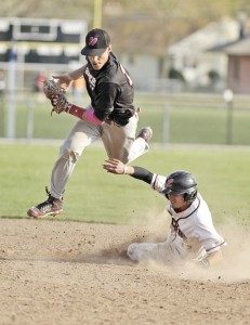 Westfield's Ashton Kennedy, left, leaps in the air after a wild pitch as Longmeadow base runner Noah Hurwitz slips under Kennedy. Hurwitz was safe. (Photo by Frederick Gore/www.thewestfieldnews.smugmug.com)