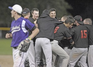 A Cathedral player, left, makes his way back to the dugout as members of the Westfield High School baseball team celebrate a dramatic comeback Tuesday night. The Bombers won 5-4. (Photo by Frederick Gore/www.thewestfieldnews.smugmug.com)