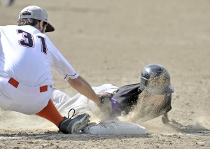 Westfield Voc-Tech's Nick Clegg, receives a face full of dirt while sliding back to first base during yesterday's game against Lee. (Photo by Frederick Gore)