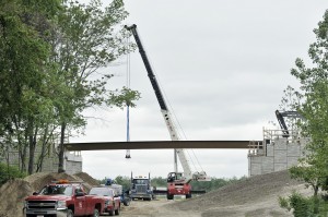 In May, contractors used a crane to place large steel beams on a support structure that will be part of the Columbia Greenway Project. The bridge is located off Ponders Hollow Road in Westfield. (File photo by Frederick Gore)