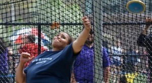 Naloti Palma unleashes her New England championship and school record setting throw in the discus. (Photo by Mickey Curtis)